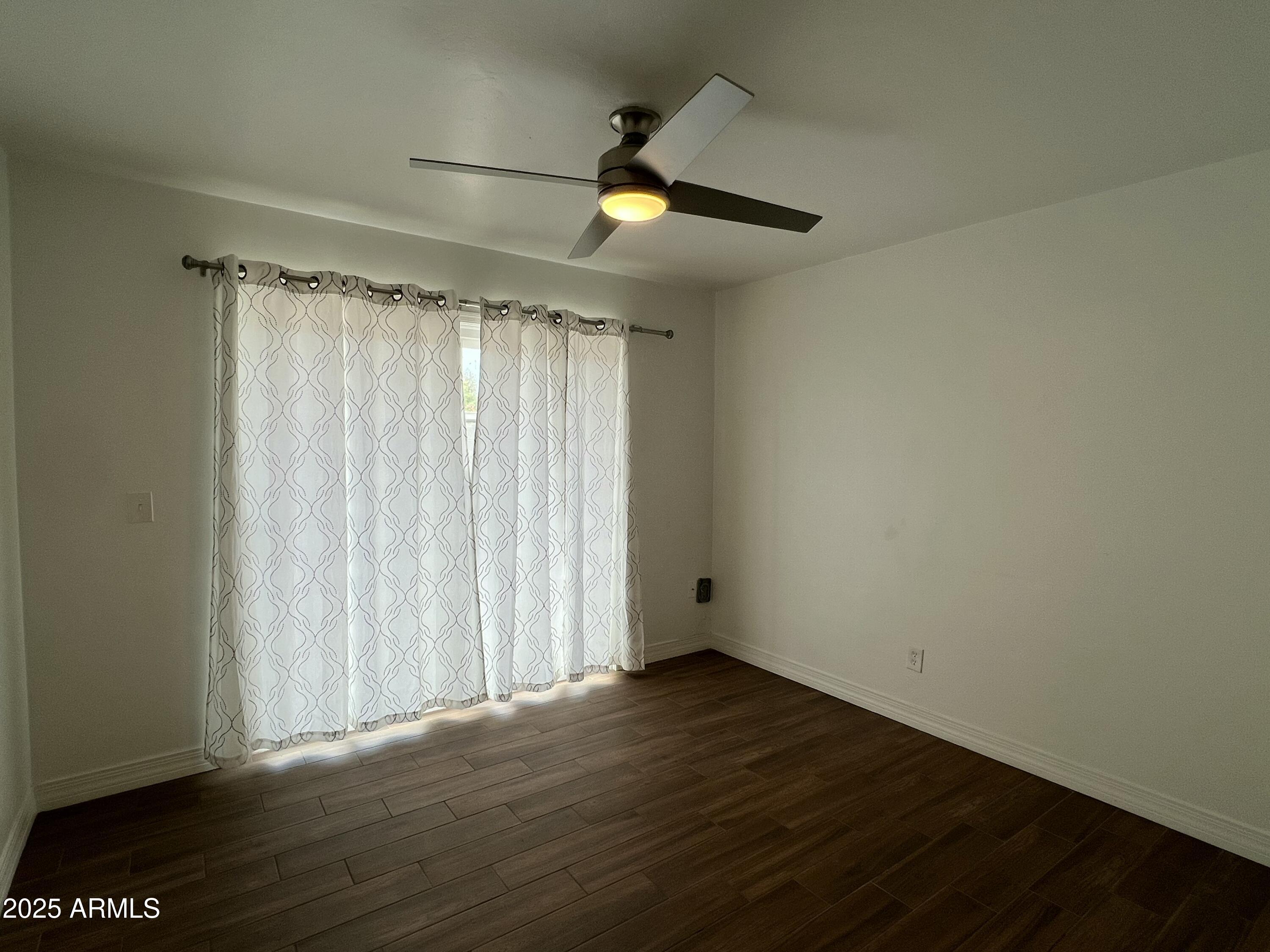 6202 North 14th Street, Unit 3/4 Phoenix, AZ 85014 - Photo 30 of 35 an empty room with wooden floor and windows