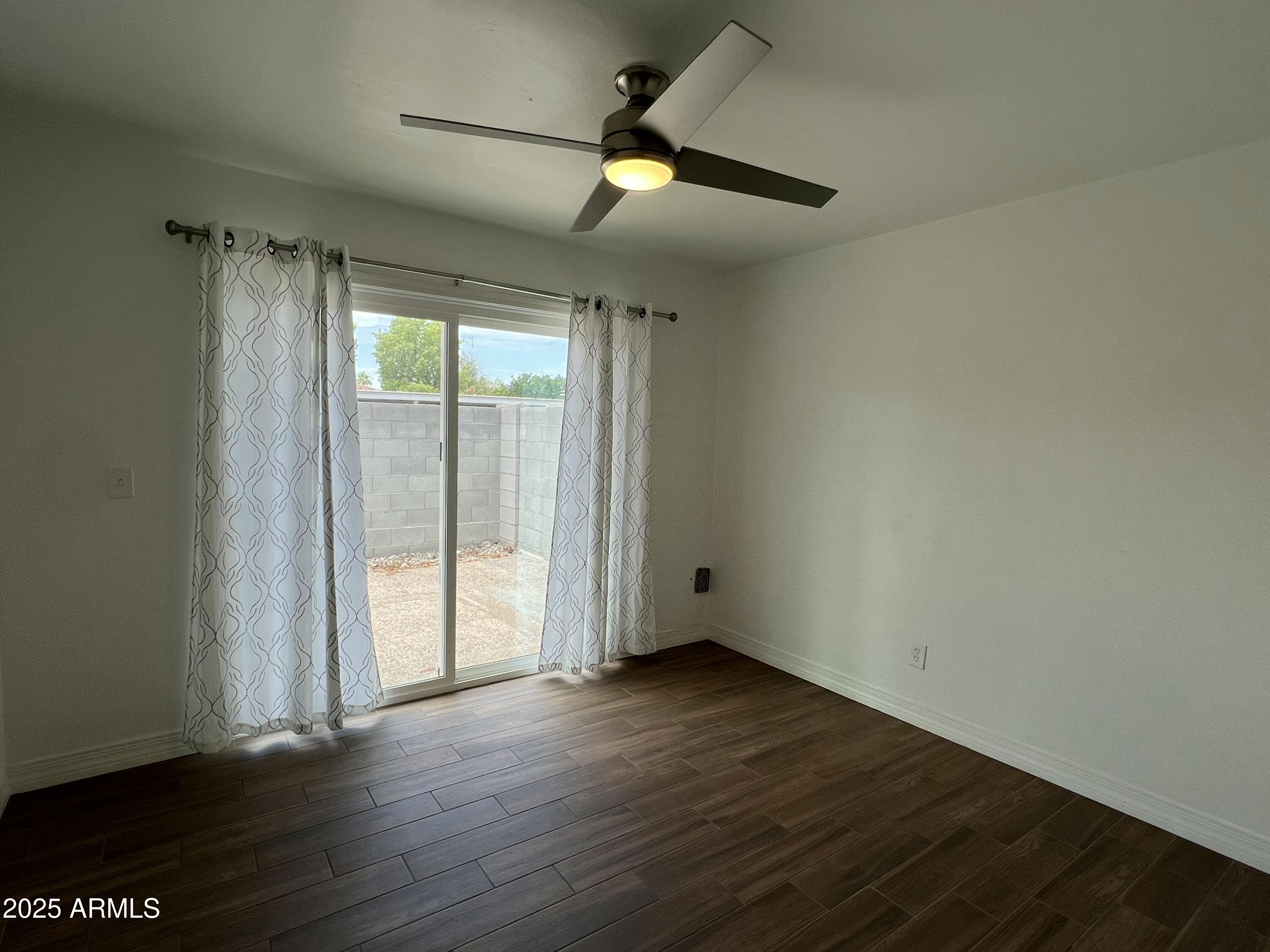 6202 North 14th Street, Unit 3/4 Phoenix, AZ 85014 - Photo 32 of 35 an empty room with wooden floor and windows