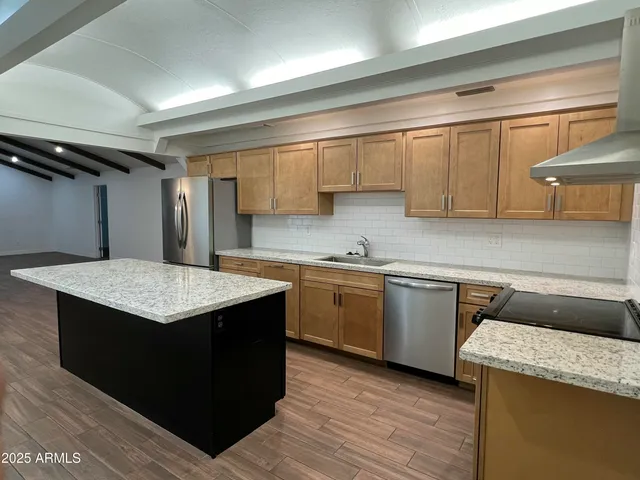 a kitchen with a sink a stove top oven and cabinets