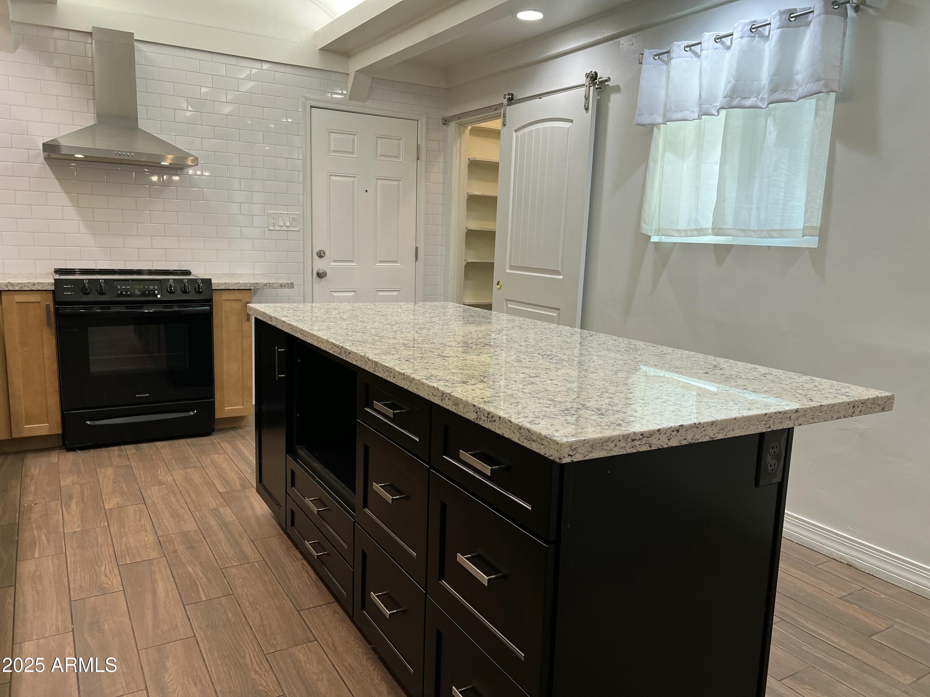 6202 North 14th Street, Unit 3/4 Phoenix, AZ 85014 - Photo 10 of 35 a kitchen with a stove a sink and a refrigerator