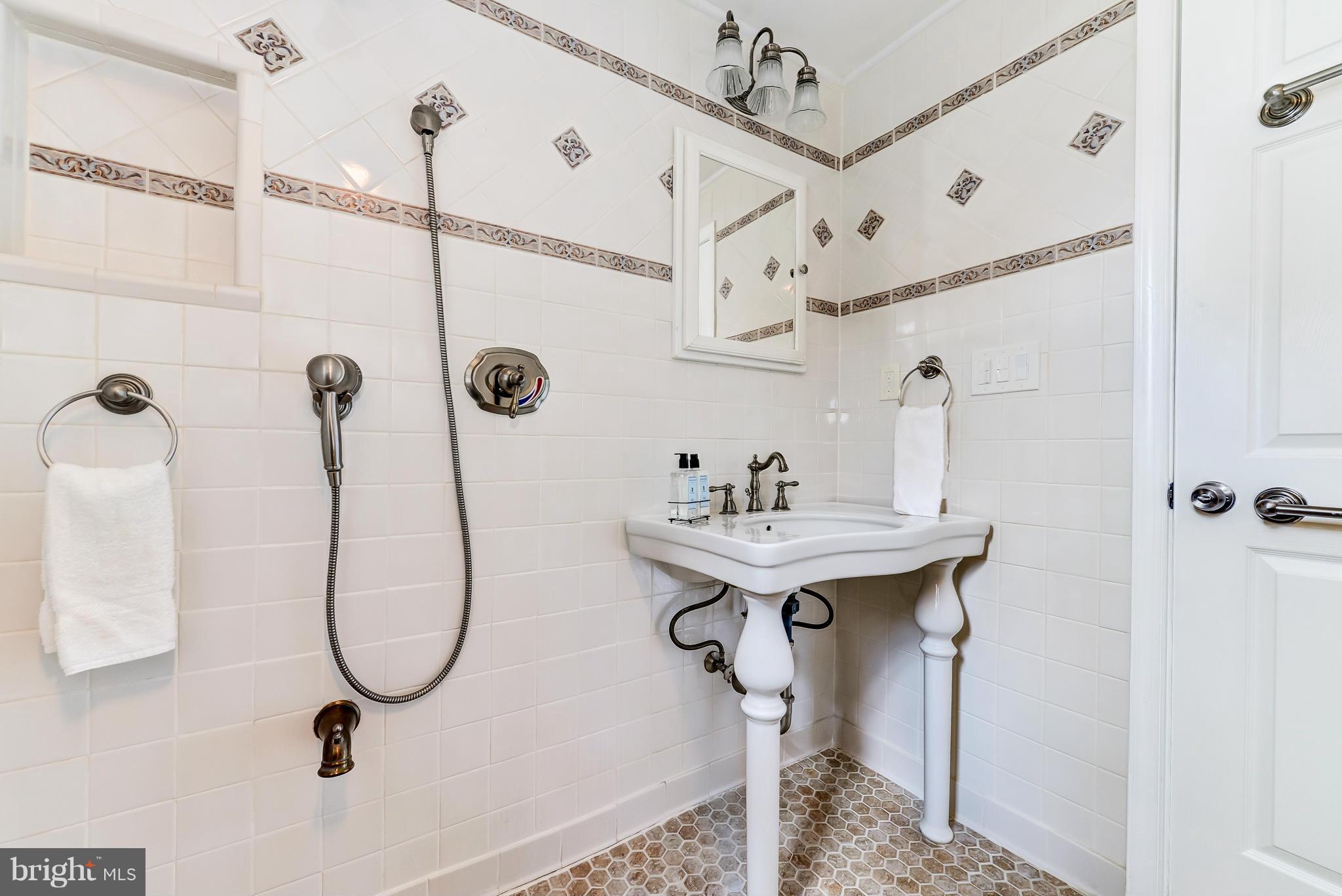 12403 Goodhill Road Silver Spring, MD 20906 - Photo 14 of 28 a bathroom with a sink a mirror and shower