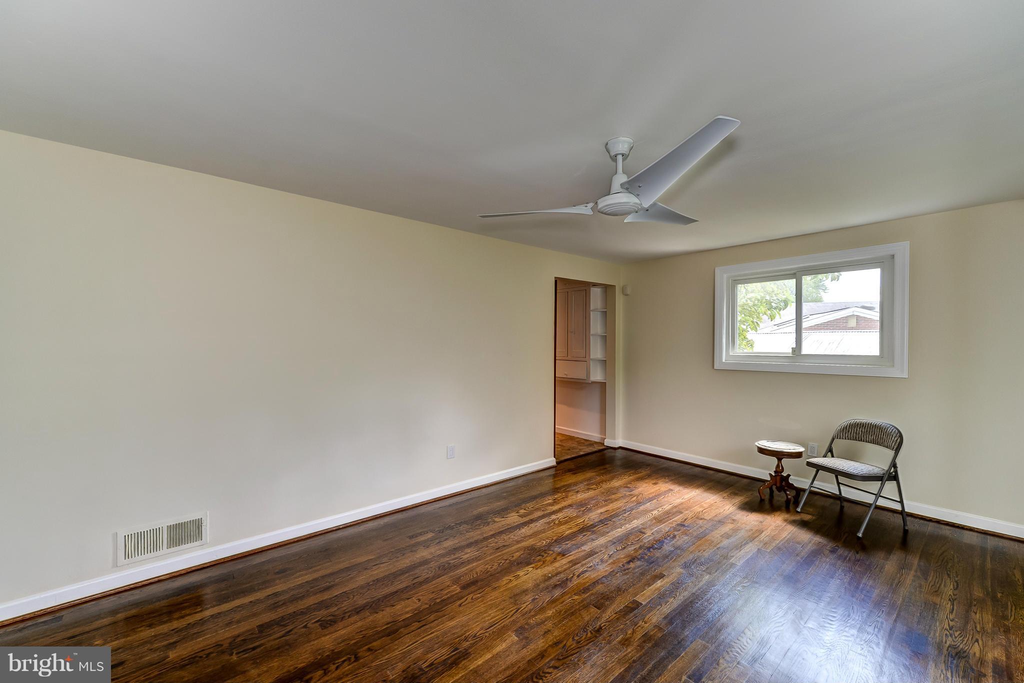 12403 Goodhill Road Silver Spring, MD 20906 - Photo 3 of 28 a view of workspace with wooden floor and a ceiling fan