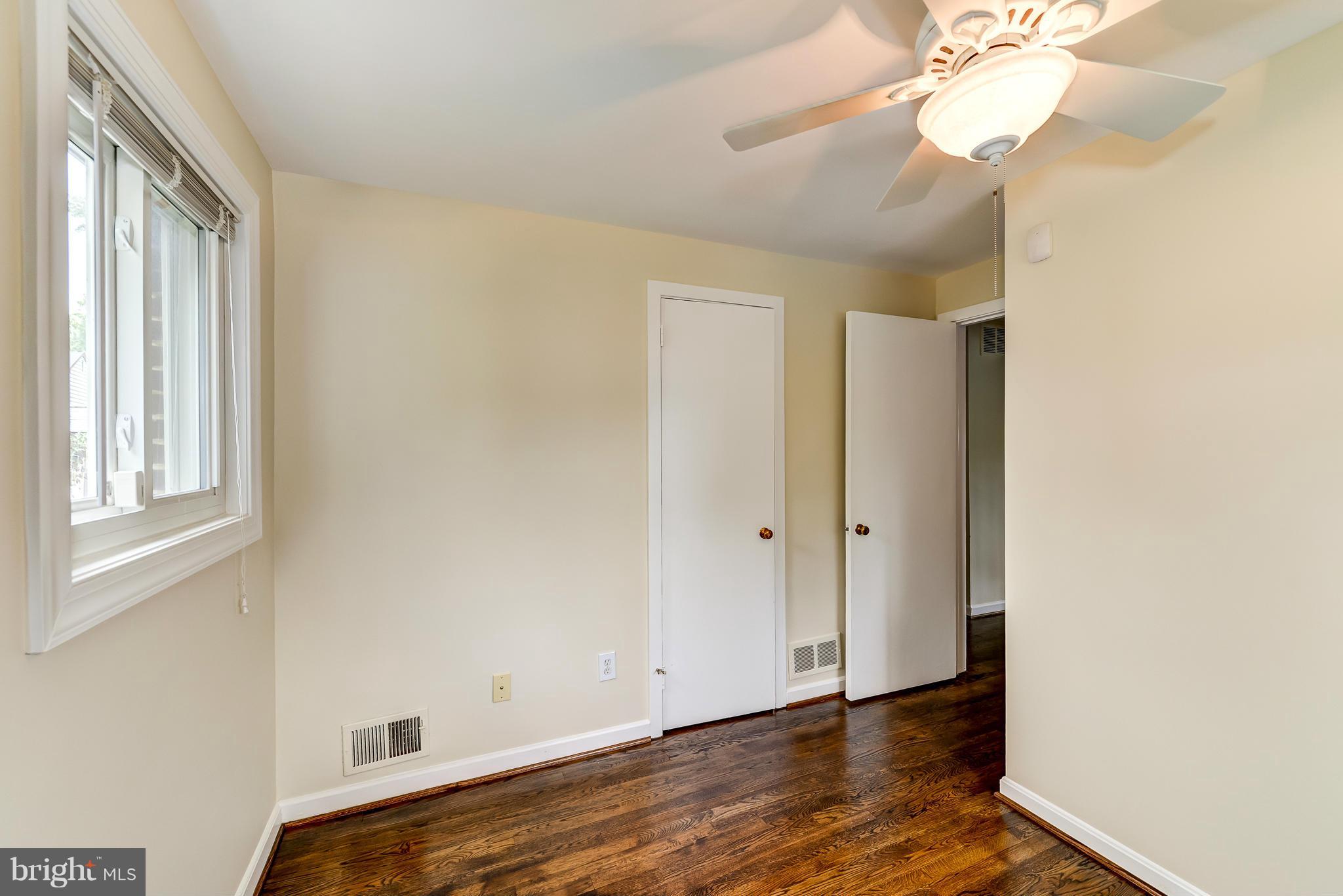 12403 Goodhill Road Silver Spring, MD 20906 - Photo 8 of 28 a view of empty room with wooden floor and fan