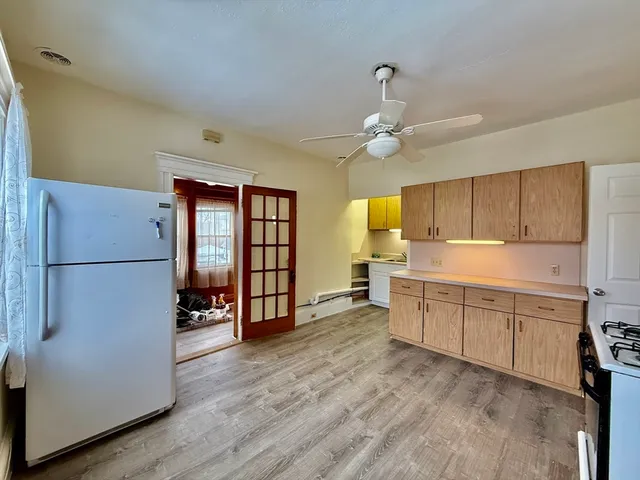 a kitchen with stainless steel appliances a refrigerator and a stove top oven