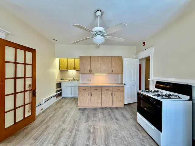 a kitchen with a stove a sink and a refrigerator