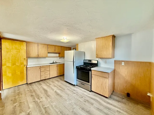 a kitchen with a stove a sink and a refrigerator