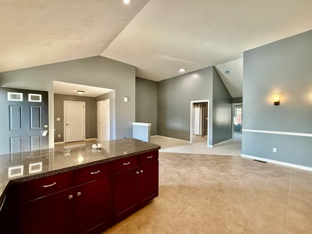 a spacious bathroom with a granite countertop sink and a mirror
