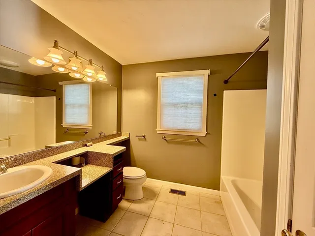 a bathroom with a sink a toilet and mirror