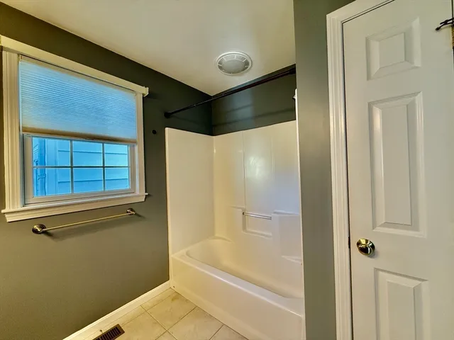 a bathroom with a shower and a tub