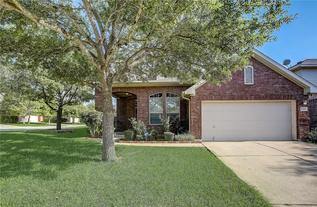 1880 Stone Rim Loop Buda, TX 78610 - Photo 1 of 1 a front view of a house with garden