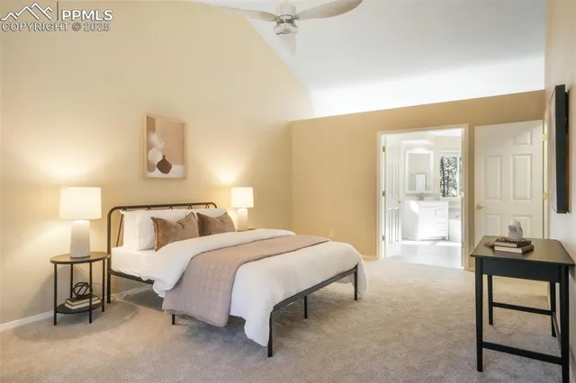 a spacious bedroom with a bed and wooden floor