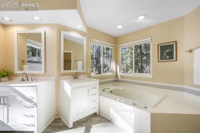 a bathroom with a bathtub sink and mirror