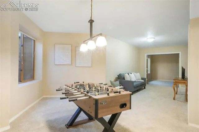 a living room with furniture a window and a flat screen tv