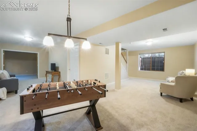 a dining room with furniture and chandelier