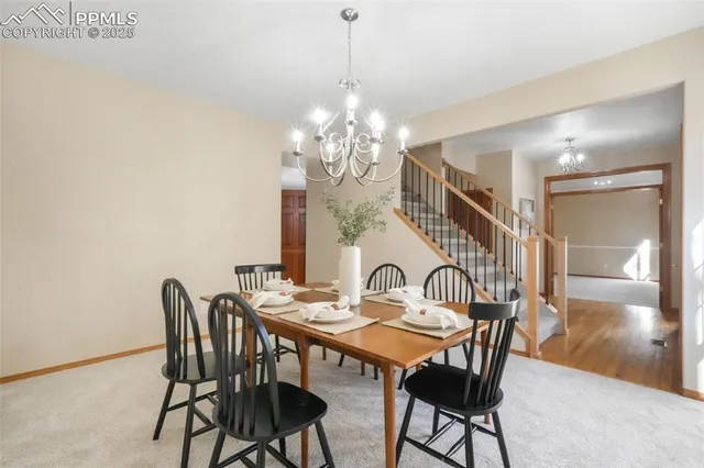 a view of a dining room with furniture and chandelier