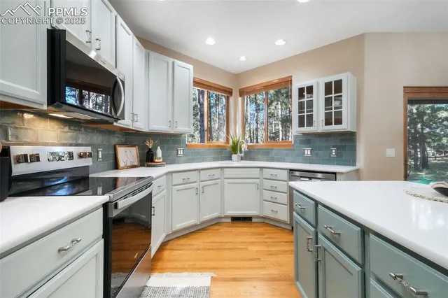 a kitchen with a sink stove and microwave