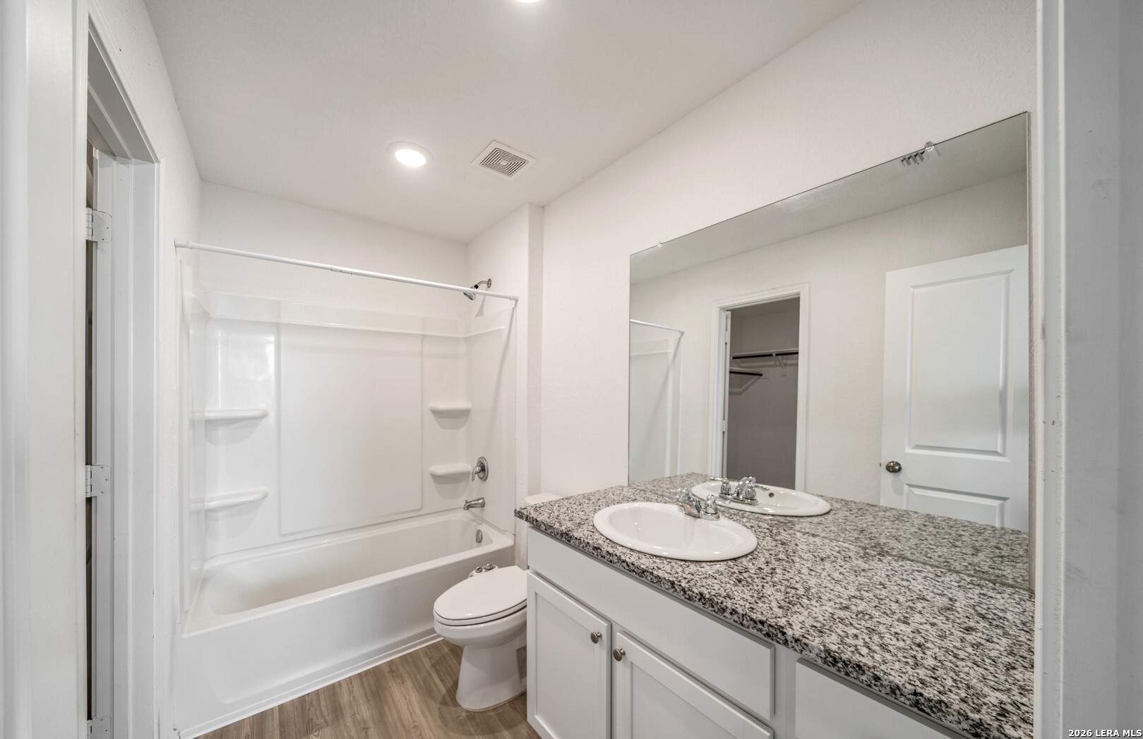 6566 Runaway Row Converse, TX 78109 - Photo 15 of 27 a bathroom with a granite countertop sink toilet and shower