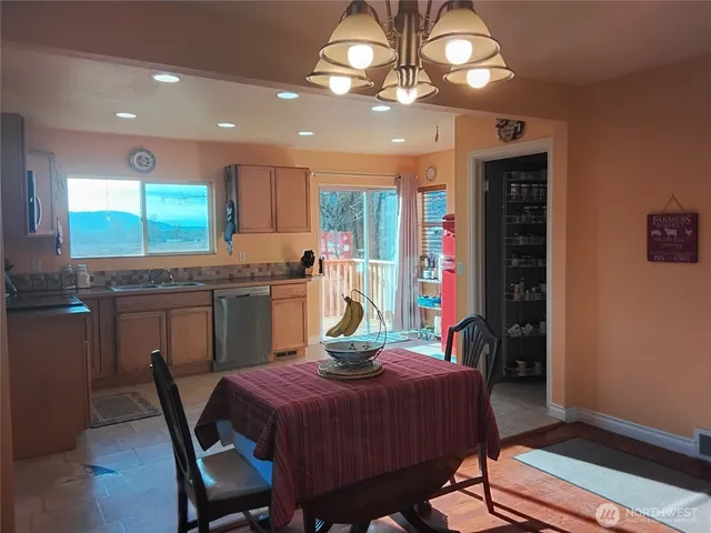 a kitchen with stainless steel appliances granite countertop a kitchen island hardwood floor and a sink