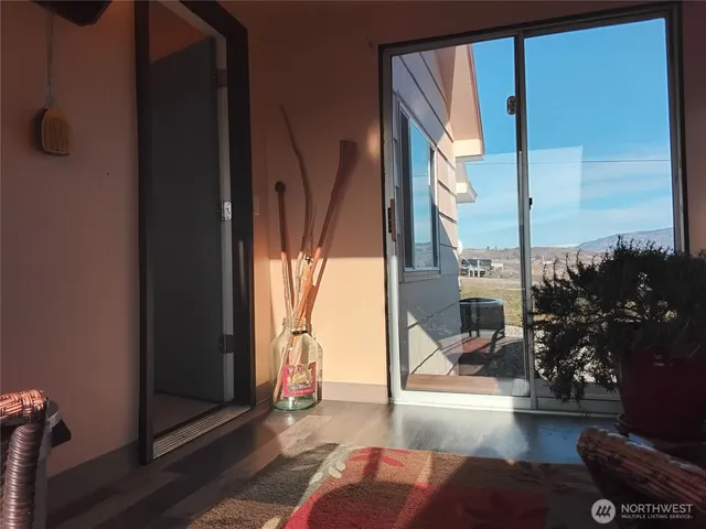 a view of living room filled with furniture and a potted plant