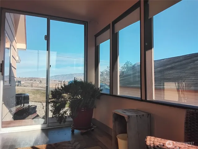 a living room with a large window and floor to ceiling window