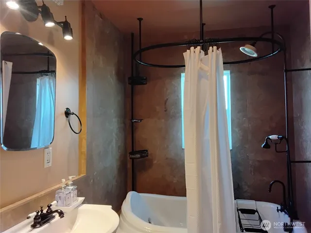 a bathroom with a shower and a toilet