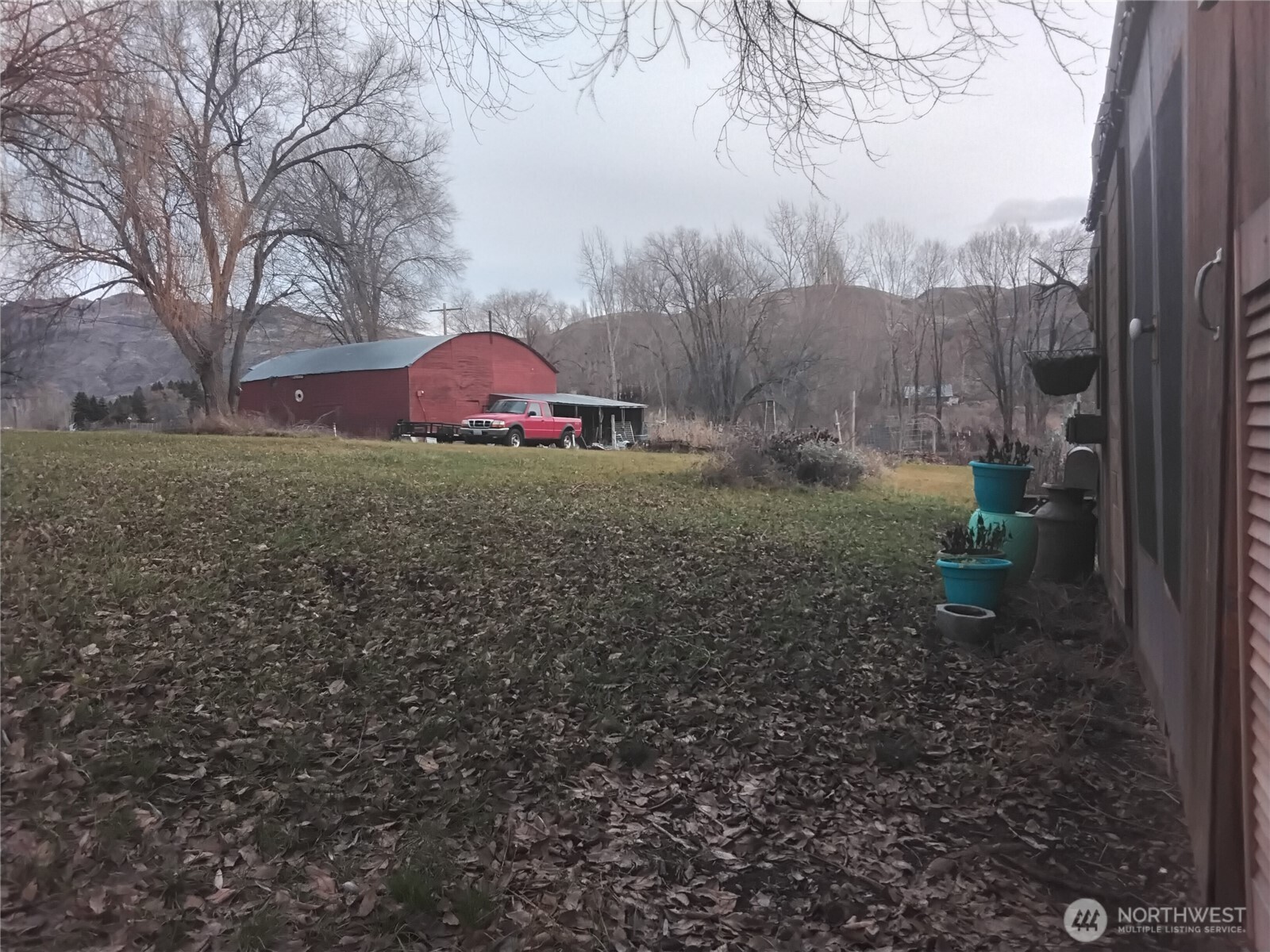 30 River Loop Road Tonasket, WA 98855 - Photo 7 of 37 a backyard of a house with lots of green space