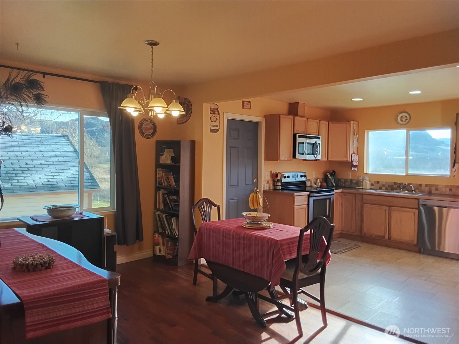 30 River Loop Road Tonasket, WA 98855 - Photo 10 of 37 a kitchen with a dining table chairs and refrigerator