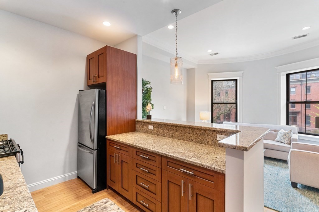 16 Worcester Square, Unit 3 Boston, MA 02118 - Photo 8 of 18 a kitchen with stainless steel appliances granite countertop a refrigerator and a sink