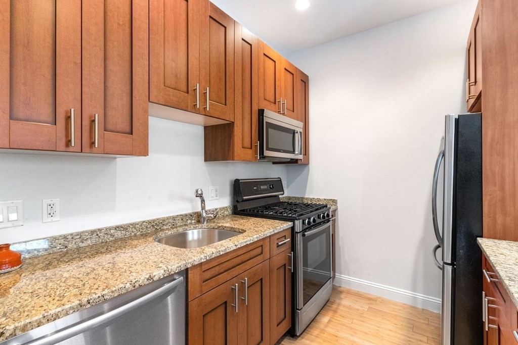 16 Worcester Square, Unit 3 Boston, MA 02118 - Photo 9 of 18 a kitchen with stainless steel appliances granite countertop a sink stove and refrigerator