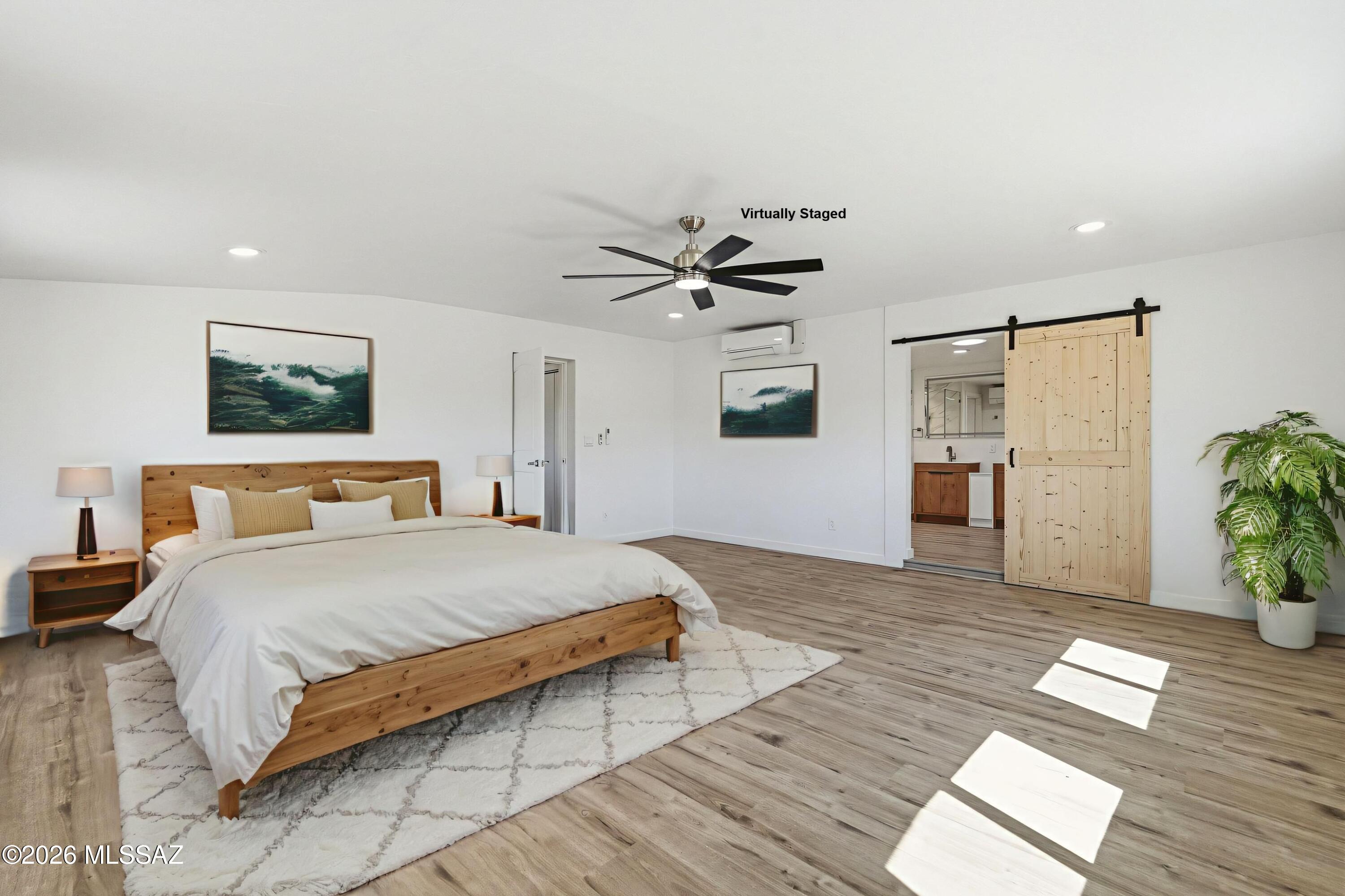 950 West Ina Road Tucson, AZ 85704 - Photo 14 of 54 a bedroom with a bed and a chandelier