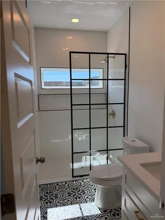 a bathroom with a toilet sink and mirror