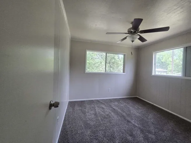 a view of room with window and ceiling fan