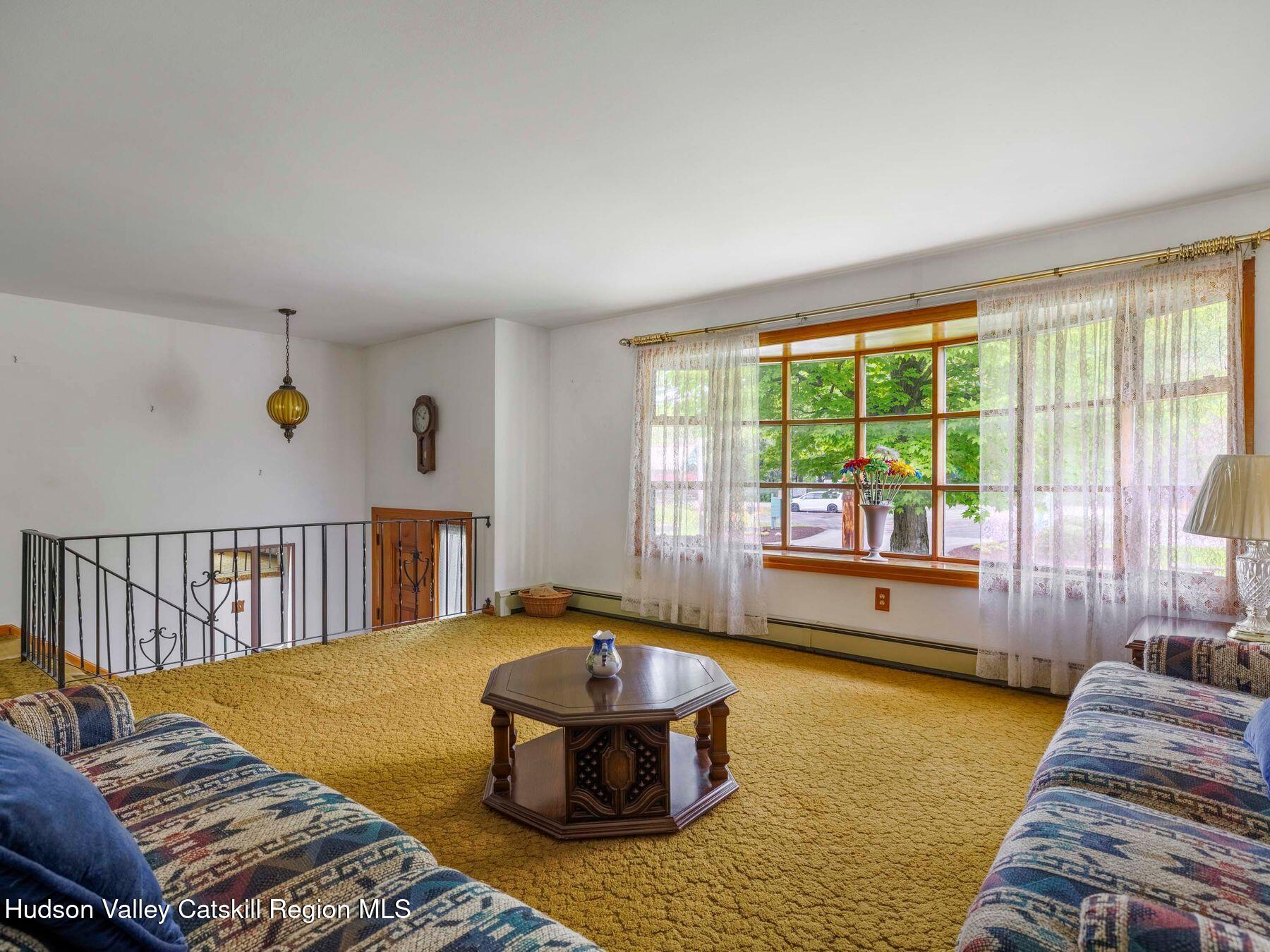 104 New Paltz Road Highland, NY 12528 - Photo 13 of 43 a living room with a bed and large window