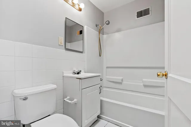 a view of staircase with white walls and white door