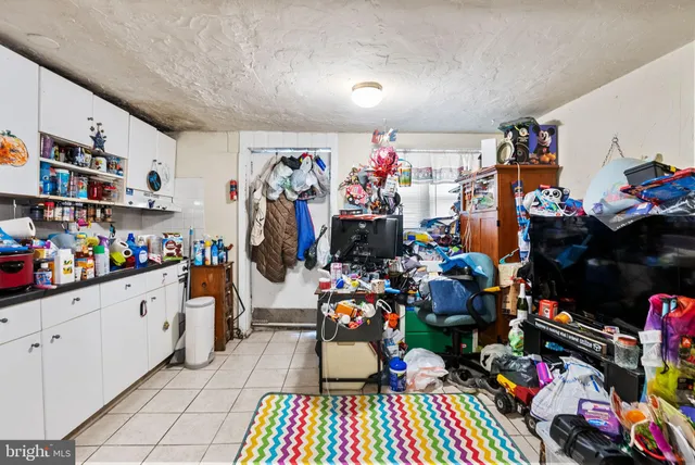 a bedroom with a bed and a baby bed