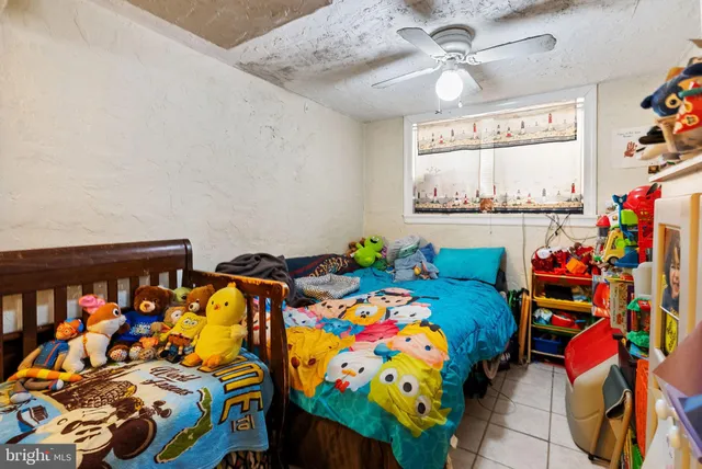 a hallway with a dining table a chandelier and a wooden floor