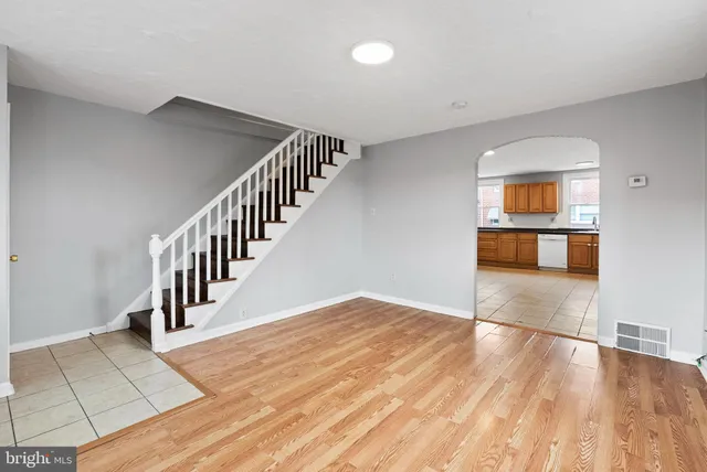 a view of a hallway with wooden floor and staircase