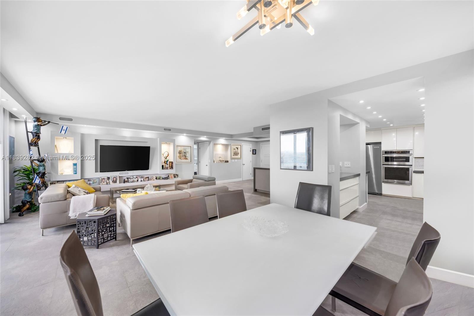 9801 Collins Avenue, Unit 16U Bal Harbour, FL 33154 - Photo 11 of 33 a large living room with stainless steel appliances kitchen island granite countertop furniture and a kitchen view