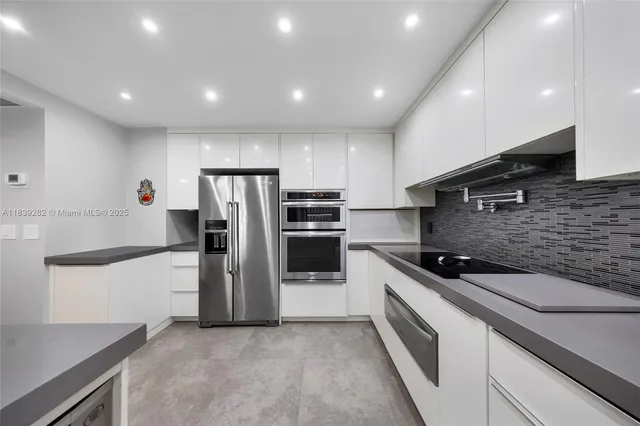 a kitchen with a sink stainless steel appliances and cabinets