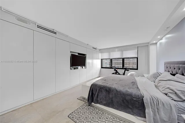 a bedroom with a bed and a television