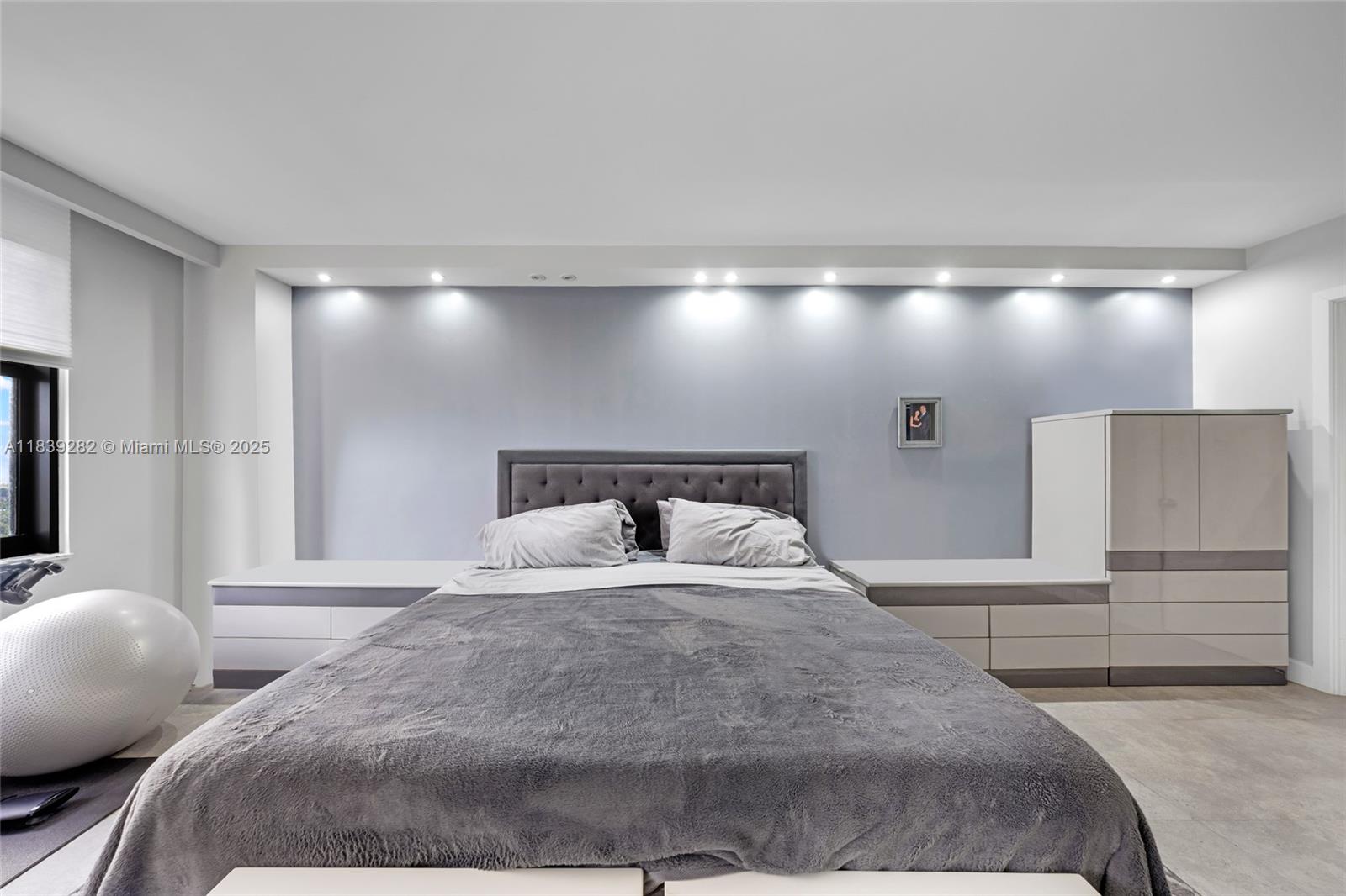 9801 Collins Avenue, Unit 16U Bal Harbour, FL 33154 - Photo 22 of 33 a bedroom with a bed and a large mirror