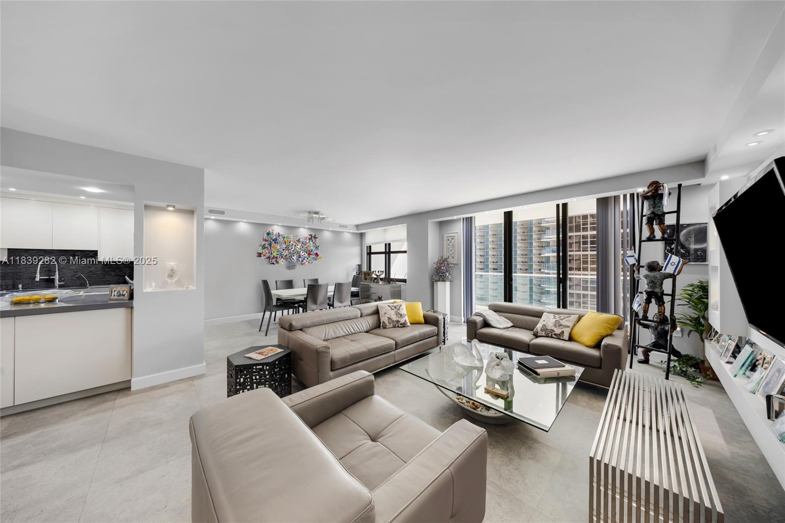 9801 Collins Avenue, Unit 16U Bal Harbour, FL 33154 - Photo 4 of 33 a living room with furniture and a flat screen tv