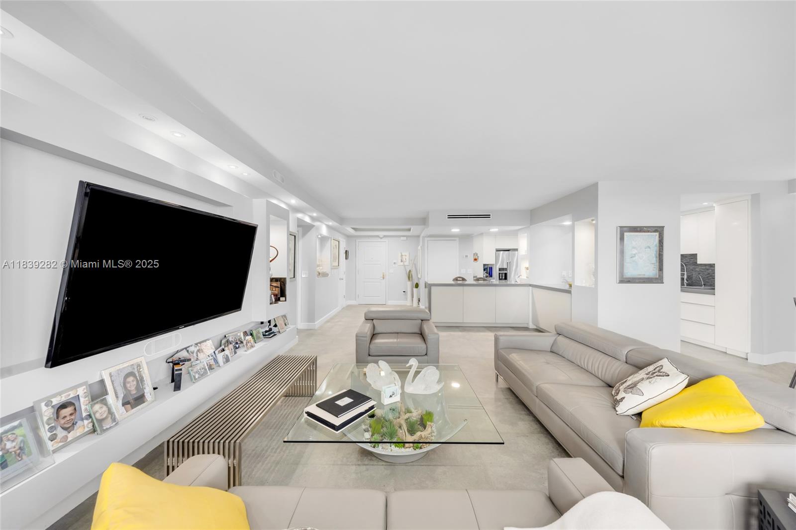 9801 Collins Avenue, Unit 16U Bal Harbour, FL 33154 - Photo 8 of 33 a living room with furniture and a flat screen tv