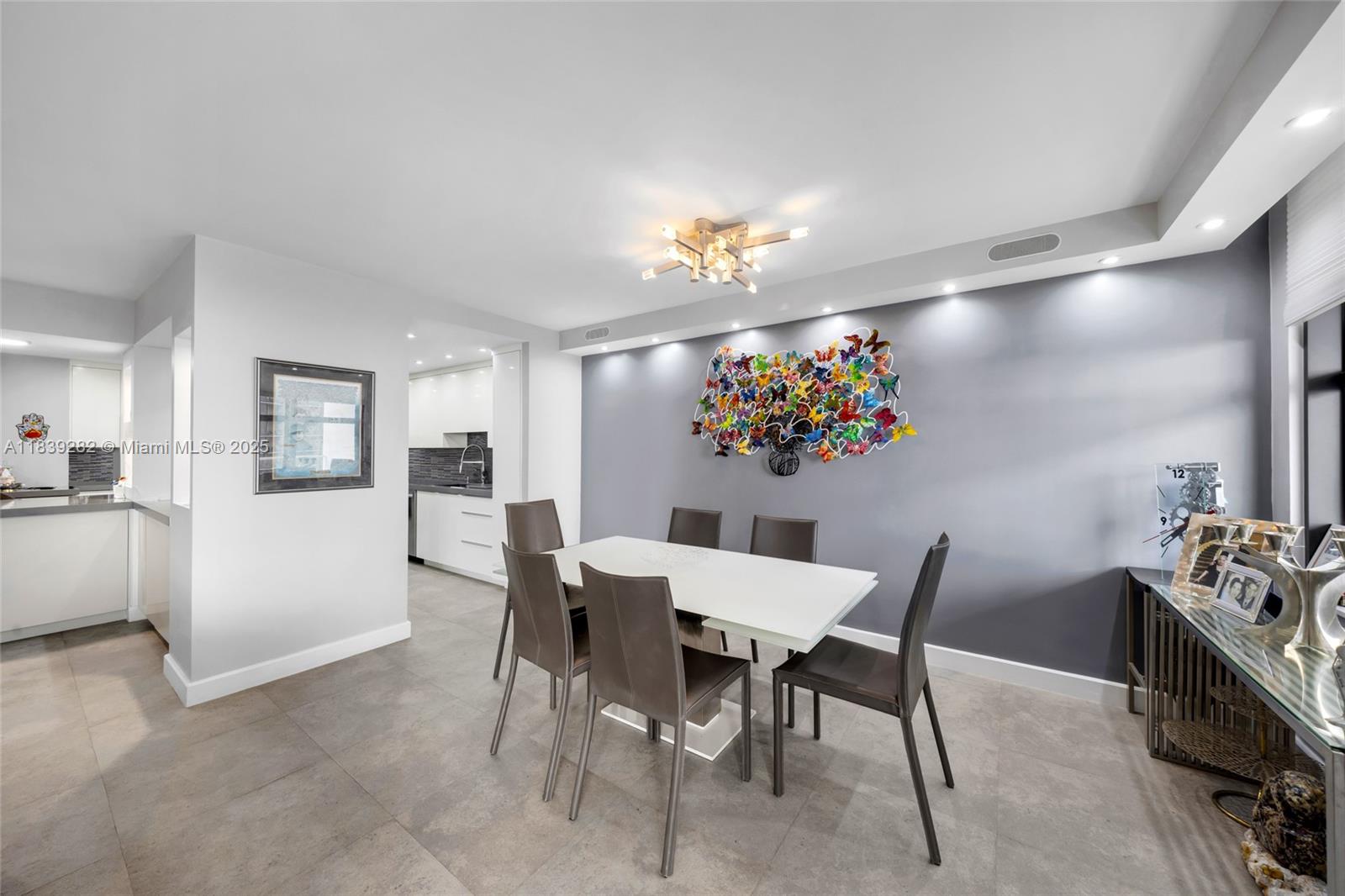 9801 Collins Avenue, Unit 16U Bal Harbour, FL 33154 - Photo 9 of 33 a view of a dining room with furniture and chandelier