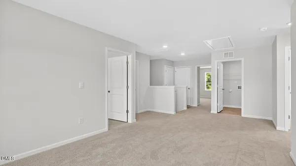 a view of an empty room and closet area