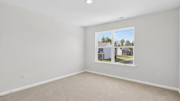 a view of an empty room and closet area