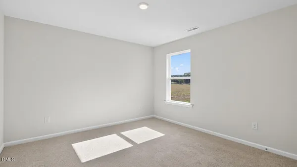 an empty room with closet area