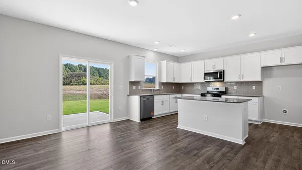 a view of a kitchen with a sink and a refrigerator