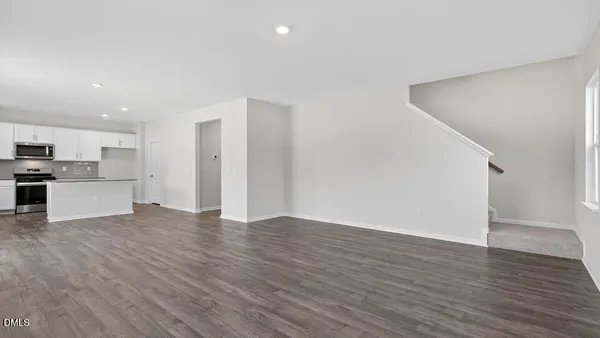 a view of kitchen with wooden floor and windows