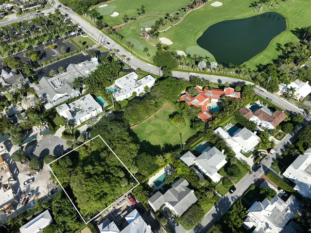 an aerial view of residential houses with outdoor space and street view